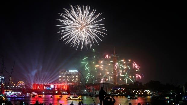 Crowds ring in 2023 with fireworks, fetes and hope for an end to 2022 challenges